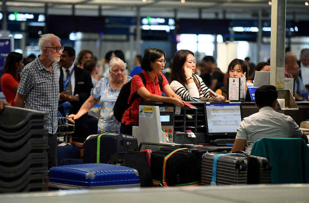 Passengers check in for their flights at KLIA in Sepang August 23, 2019. — Bernama pic
