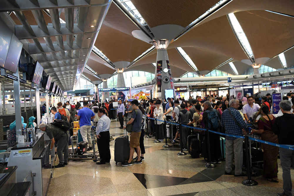 Passengers check in for their flights at KLIA in Sepang August 23, 2019. u00e2u20acu201d Bernama pic