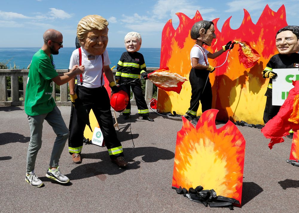 Oxfam activists wearing giant papier mache heads depicting G7 leaders pose dressed as firemen to draw attention to fighting inequality, on the eve of the G7 summit in Biarritz, France, August 23, 2019. u00e2u20acu201d Reuters pic