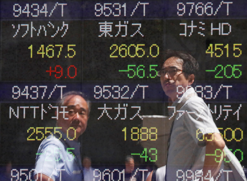 Passersby are reflected on a stock quotation board outside a brokerage in Tokyo, Japan, August 6, 2019. u00e2u20acu201d Reuters pic 