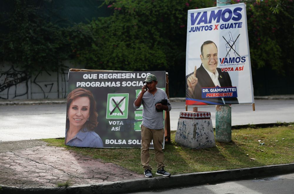 A man cross a street in front of campaign signs for Sandra Torres, presidential candidate for UNE and Alejandro Giammattei, presidential candidate for the u00e2u20acu02dcVamosu00e2u20acu2122 political party, in Chinautla, Guatemala August 9, 2019. u00e2u20acu201d Reuters pic