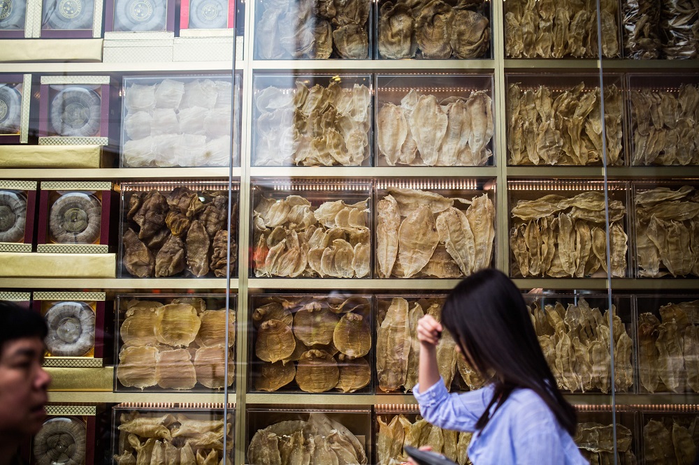 This file photo taken on March 29, 2016 shows pedestrians walking past a display of different varieties of dried fish maws in a shop front in Hong Kong. u00e2u20acu2022 AFP pic  