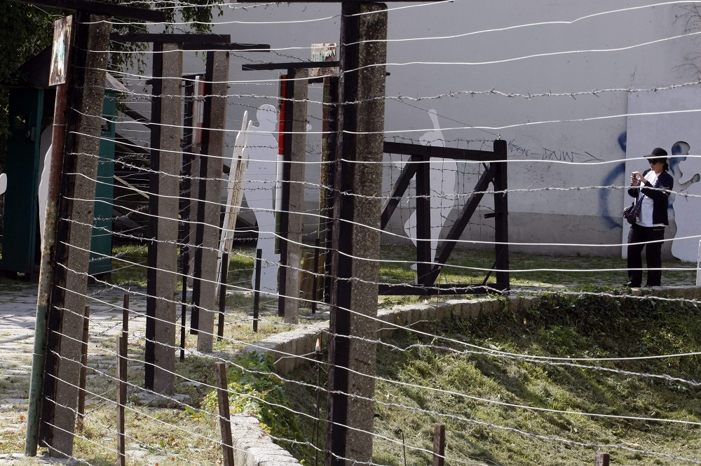 This photo taken on August 19, 2009 shows a visitor taking pictures of a removed piece of  the u00e2u20acu02dcIron Curtainu00e2u20acu2122 at an exhibition held near the border fence of the late Communist regime in Sopron, some 210km from Budapest. u00e2u20acu201d AFP pic           