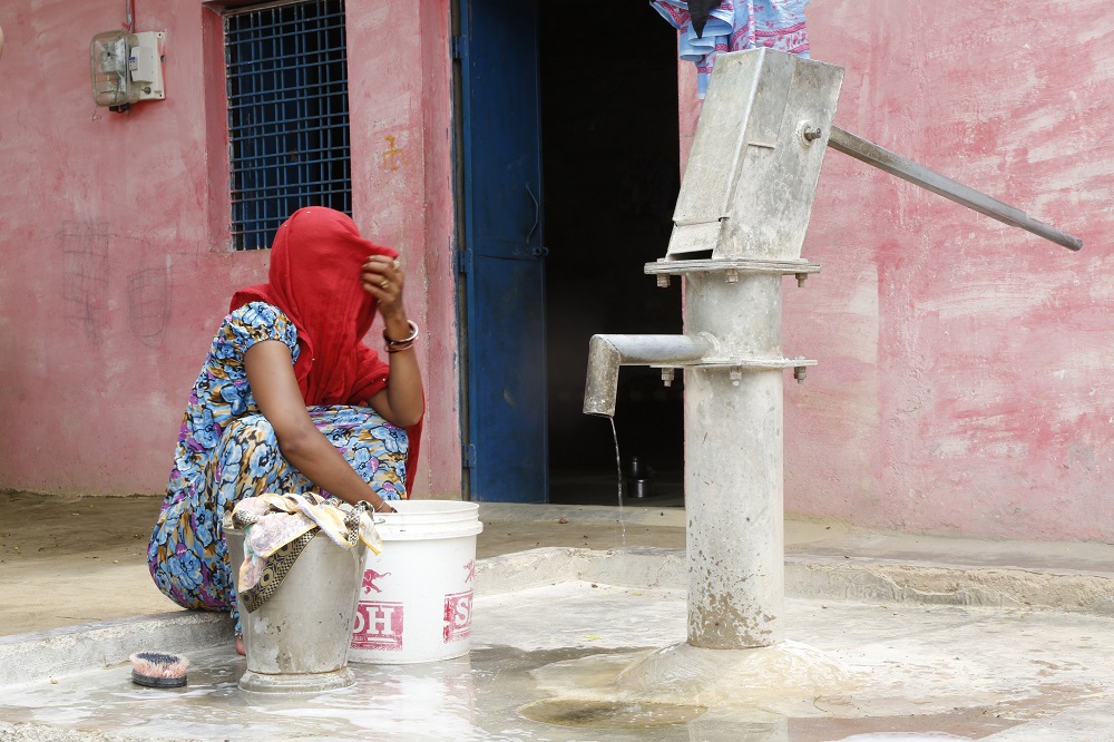 A woman washes clothes at one of the few functioning hand pumps in Baragaon village in the drought-parched central region of Bundelkhand, India July 17, 2019. u00e2u20acu201d Thomson Reuters Foundation pic