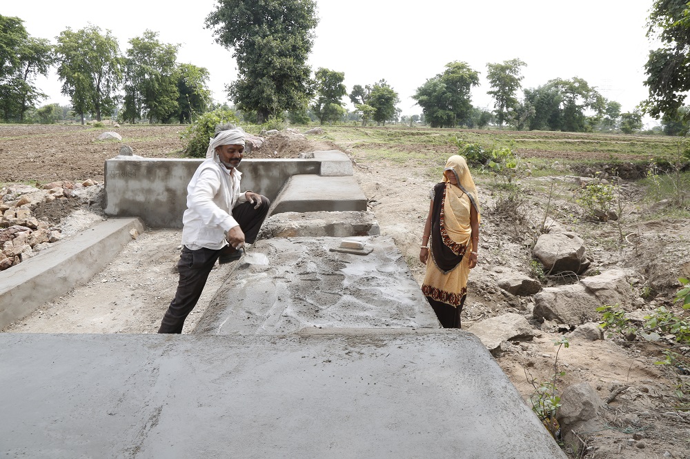 Kiran Aherwal, a Jal Saheli, or a woman water friend, supervises the making of a water outlet in Agroutha village of Bundelkhand, India July 16, 2019. — Thomson Reuters Foundation pic