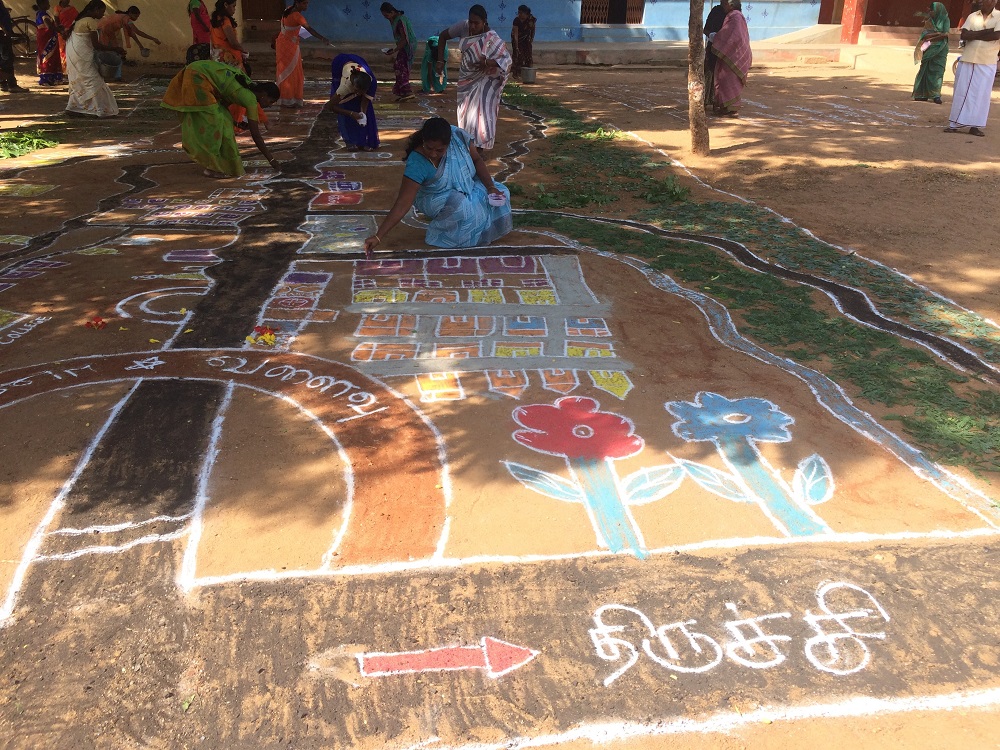Women drawing a community map using the kolam art form in Ayyampatty in southern state of Tamil Nadu, India July 14, 2019. u00e2u20acu201d Thomson Reuters Foundation pic
