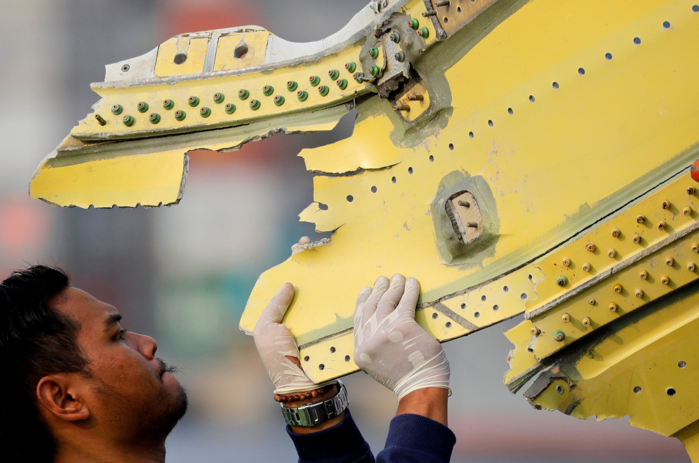 An Indonesian National Transportation Safety Commission (KNKT) official carries debris from the crashed Lion Air flight JT610 at Tanjung Priok port in Jakarta, Indonesia November 4, 2018. u00e2u20acu201d Reuters pic 