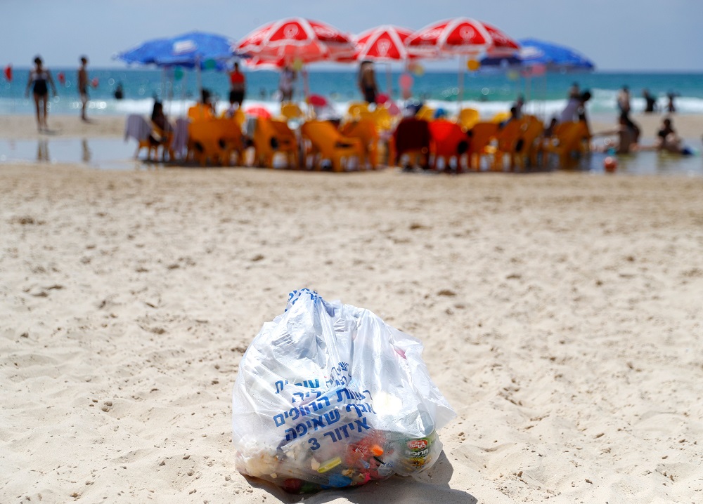 A plastic garbage bag is deposited on the beach of Hezliya, waiting to be picked up by the employees of the town hall of the Israeli coastal city June 21, 2019. u00e2u20acu2022 AFP pic          