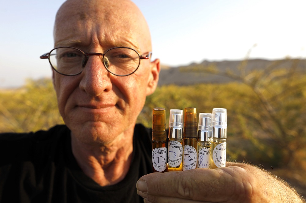 Israeli farmer Guy Erlich shows ampoules of scented oils extracted from plants and trees at a farm on a small hill near the settlement of Almog in the Israeli-occupied West Bank May 28, 2019. u00e2u20acu201d AFP pic          