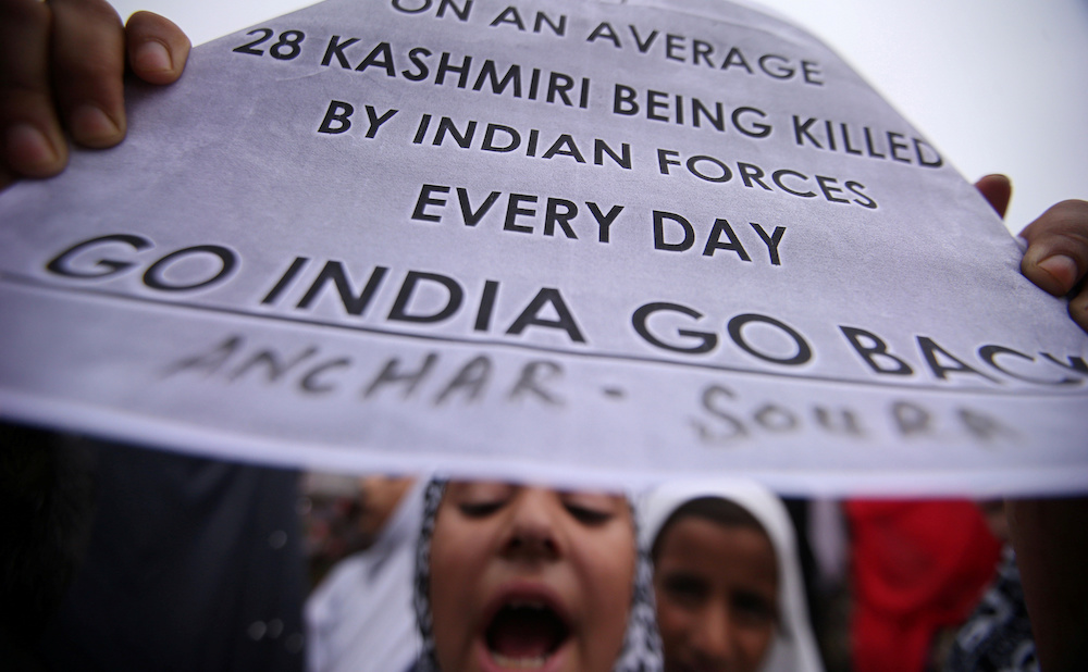A Kashmiri girl displays a placard as she shouts slogans at a protest after Friday prayers during restrictions after the Indian government scrapped the special constitutional status for Kashmir, in Srinagar August 16, 2019. u00e2u20acu201d Reuters pic