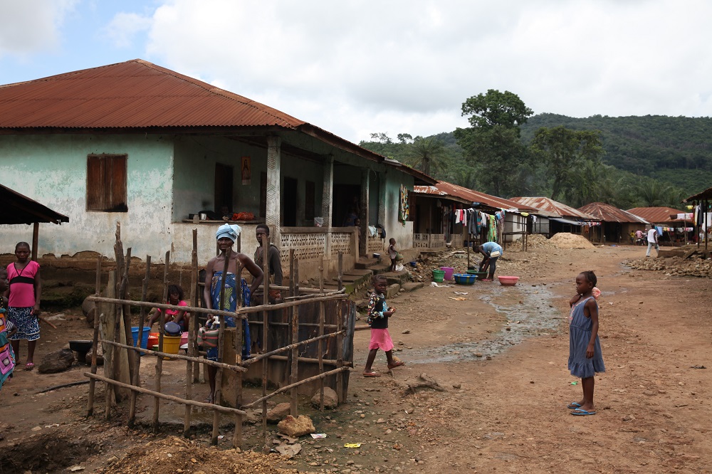 A woman stands at the water pump in Masumbiri, Tonkolili district, Sierra Leone July 26, 2019. u00e2u20acu2022 Thomson Reuters Foundation pic