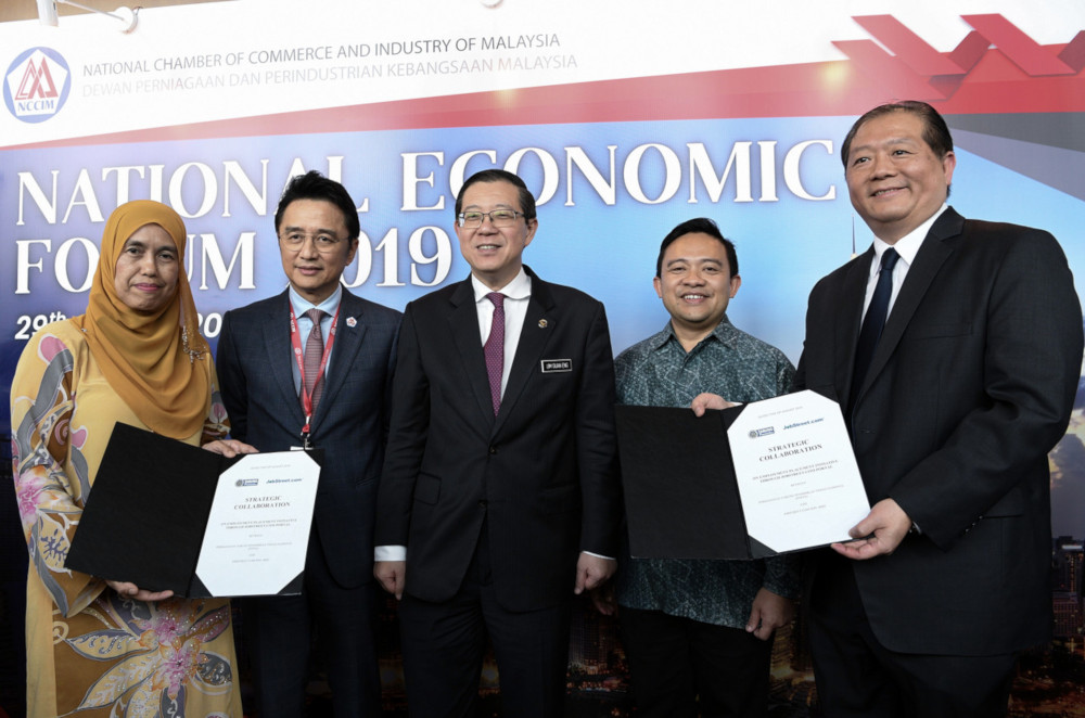 Finance Minister Lim Guan Eng with PTPTN chairman Wan Saiful Wan Jan (2nd right) after the MOU signing ceremony at the Kuala Lumpur Convention Centre August 29, 2019. u00e2u20acu201d Bernama pic    