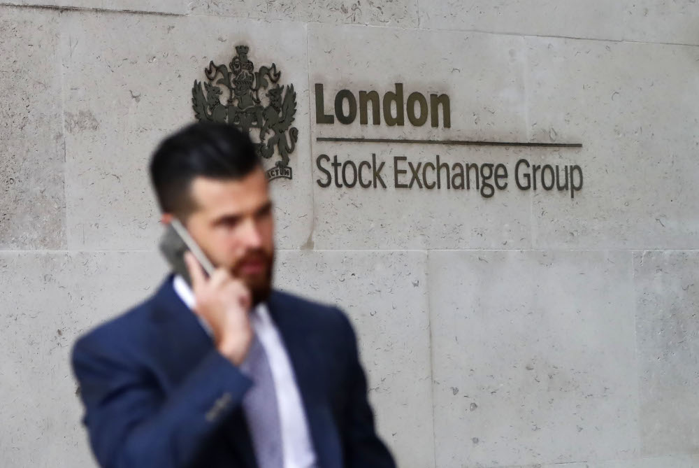 In this file photo taken August 9, 2017 commuters walk past the London Stock Exchange in the City of London. u00e2u20acu201d AFP pic