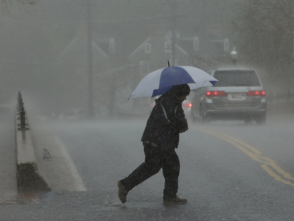 A man walks in a torrential downpour in Ellicott City, Maryland April 30, 2014. u00e2u20acu201d Reuters pic       