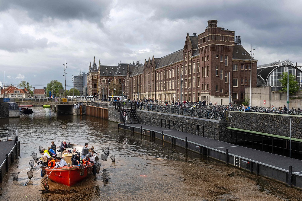 In this file photo taken on April 28, 2019, volunteers fish plastic out of a canal as they take part in the annual Kings Fishing to make the canals plastic-free again organised by the Plastic Whale Foundation in Amsterdam. u00e2u20acu201d AFP pic       