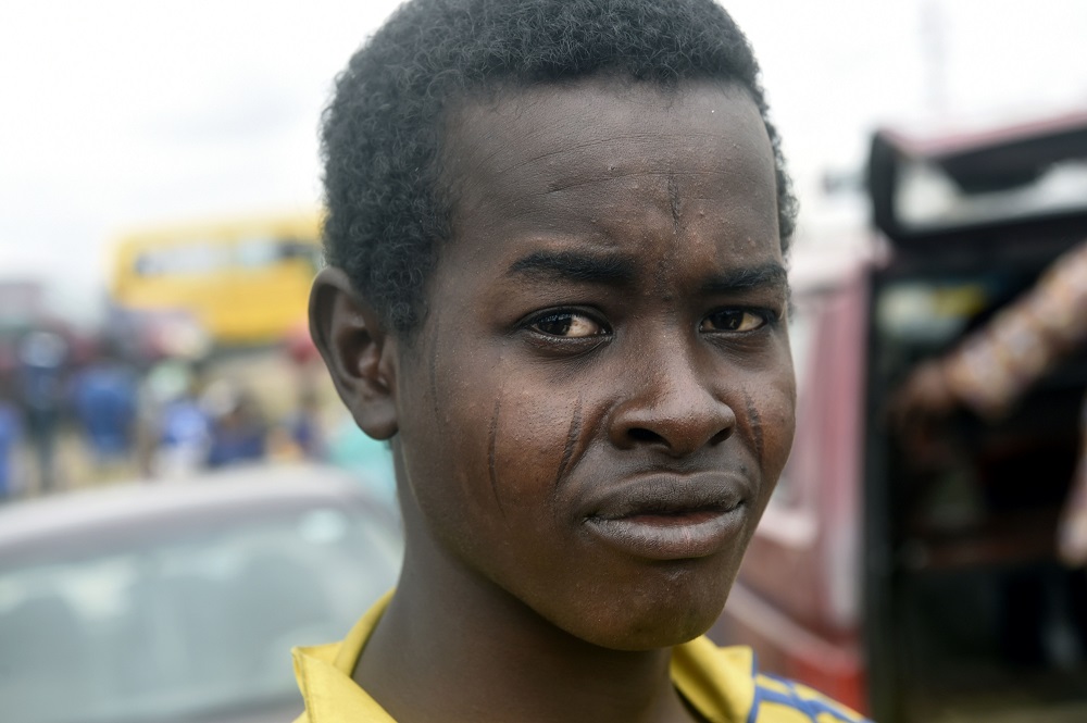 A young man bearing tribal marks on his cheeks looks on at Kara cattle market, Isheri in Ogun State, southwest Nigeria August 9, 2019. u00e2u20acu201d AFP pic        