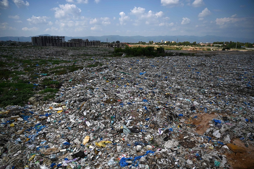 This picture taken on July 30, 2019 shows a general view of a trash site full of plastic bags on the outskirts of Islamabad. u00e2u20acu201d AFP pic       