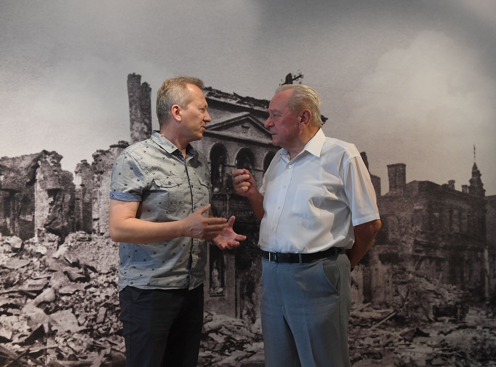 Jan Ksiazek, a historian and director of a local museum talks with historian Tadeusz Olejnik in front a picture of the destroyed town in Wielun, Poland on August 20, 2019. u00e2u20acu201d AFP pic 