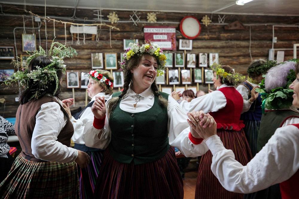 Villagers and visiting Latvians perform a traditional dance during a reception at a village club in Bobrovka, some 350km of Omsk July 31, 2019. u00e2u20acu201d AFP pic         