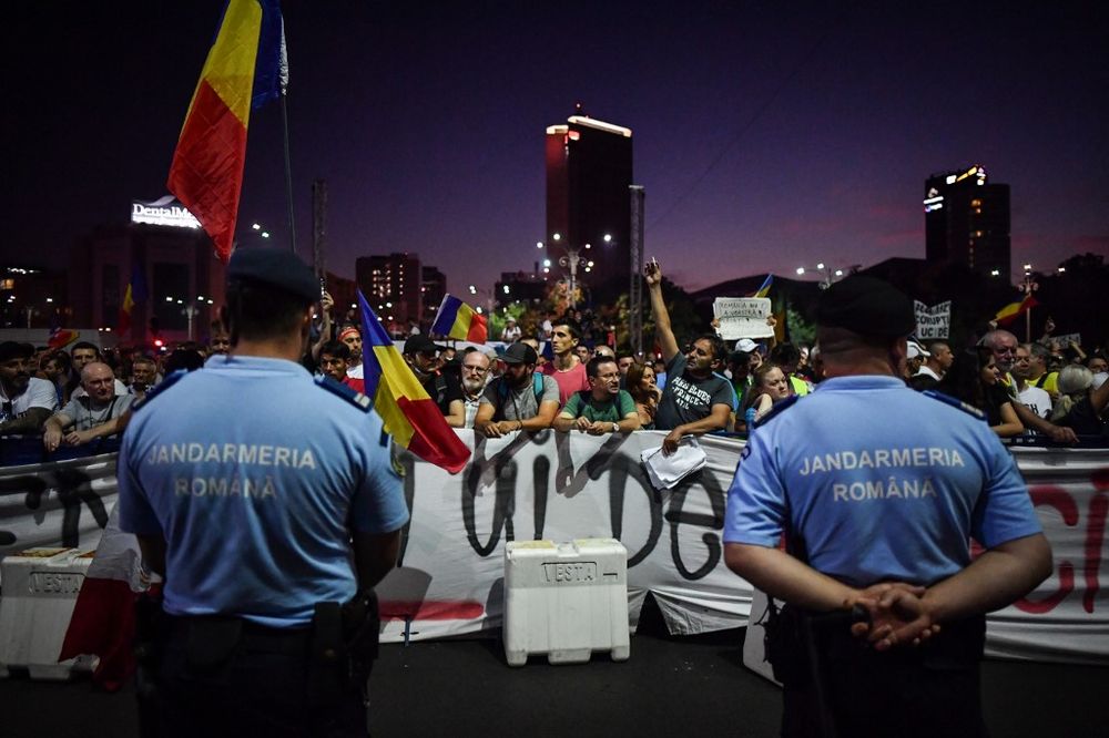 Romanian Gendarmes stand ready in front of protesters during a protest against the government and the Social Democratic ruling Party in front of the Romanian Government headquarters in Bucharest, August 10, 2019. u00e2u20acu201d AFP pic