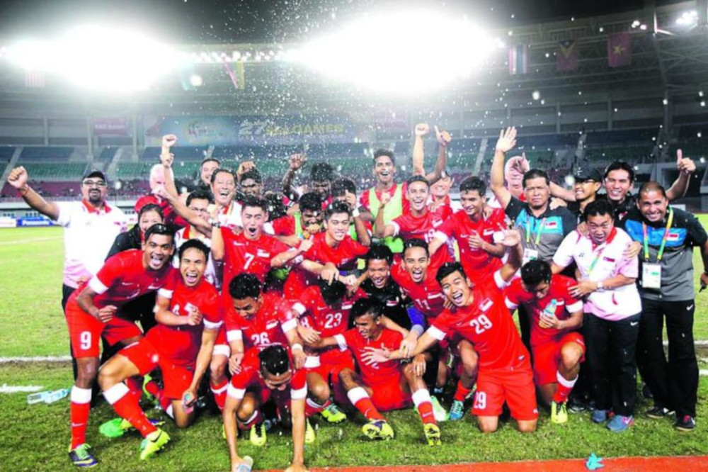 Singaporeu00e2u20acu2122s Under-23 team celebrating winning the bronze medal at the 2013 SEA Games in Myanmar. Pundits said Singapore should set a goal of winning its first SEA Games football title first. u00e2u20acu201d TODAY file pic