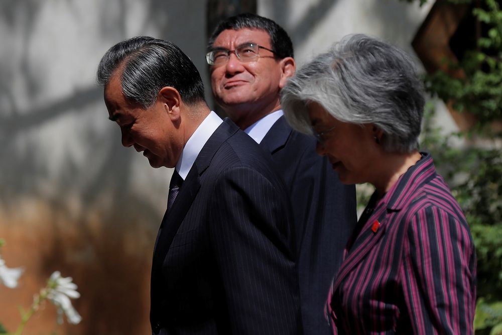 Chinese Foreign Minister Wang Yi (left), Japanese Foreign Minister Taro Kono (centre) and South Korean Foreign Minister Kang Kyung-wha walk on to a press conference after the ninth trilateral foreign ministersu00e2u20acu2122 meeting at Gubei Town in Beijing, China, A