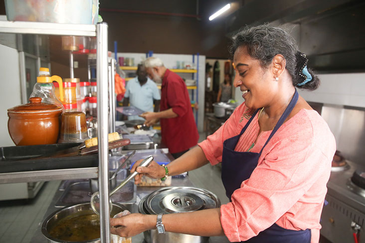 Assisting Samy with the cooking is his wife, N. Shanti.