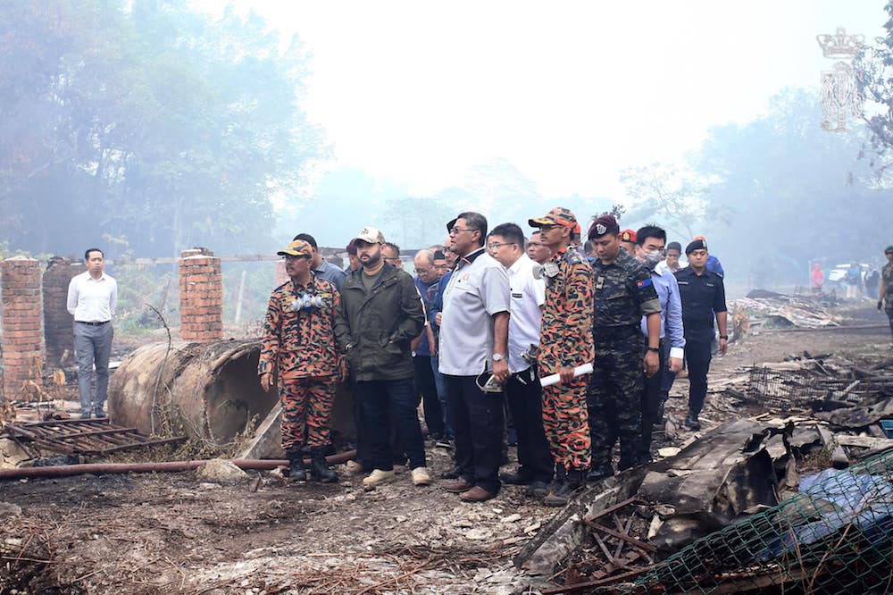 Tan Chen Choon accompanies the Regent of Johor, Tunku Ismail Sultan Ibrahim, as he surveys the fire damage in Gelang Patah August 26, 2019. u00e2u20acu201d Picture via Facebook/HRH Crown Prince of Johor