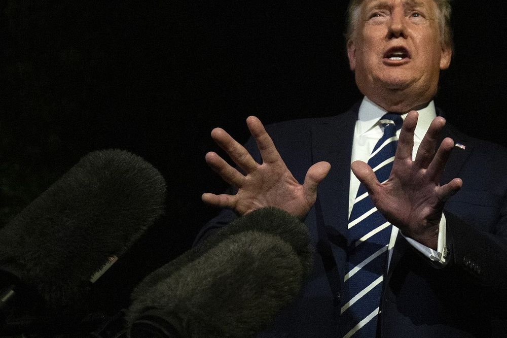 US President Donald Trump gestures as he speaks to the press while departing the White House in Washington DC, on August 23, 2019, for the G7 Summit in France. u00e2u20acu201d AFP pic