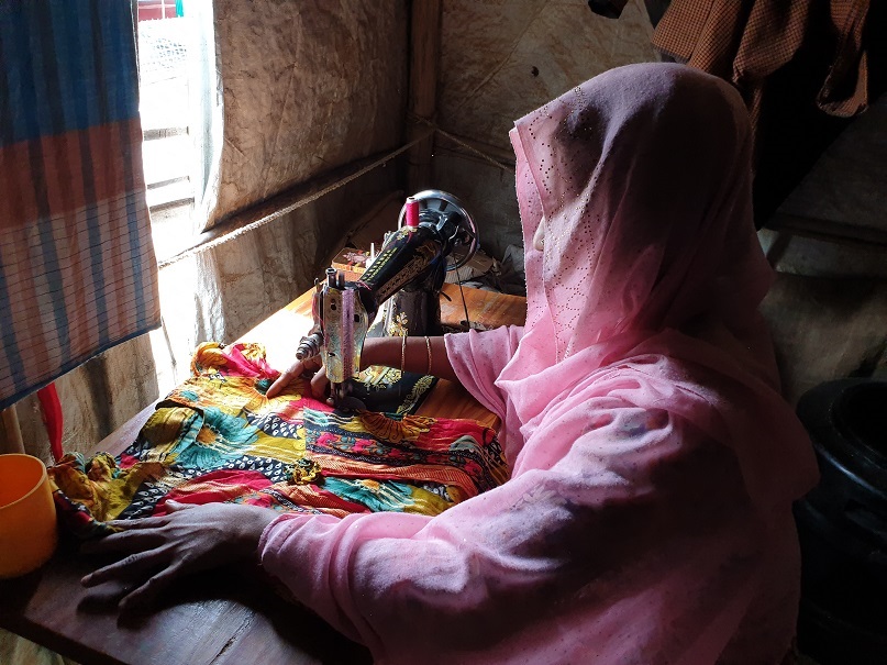 Shofika Begum, a Rohingya who was raped two years ago in Myanmar and today leads a group of female tailors in the refugee camps in South East Bangladesh who sell clothes for a living, stitches a dress at her home August 5, 2019. u00e2u20acu201d Thomson Reuters Founda