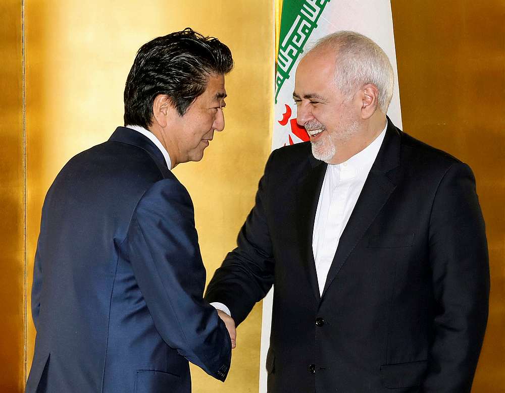Japan's Prime Minister Shinzo Abe greets Iran's Foreign Minister Mohammad Javad Zarif at the start of their meeting in Yokohama, Japan August 28, 2019. u00e2u20acu201d Kyodo pic via Reuters