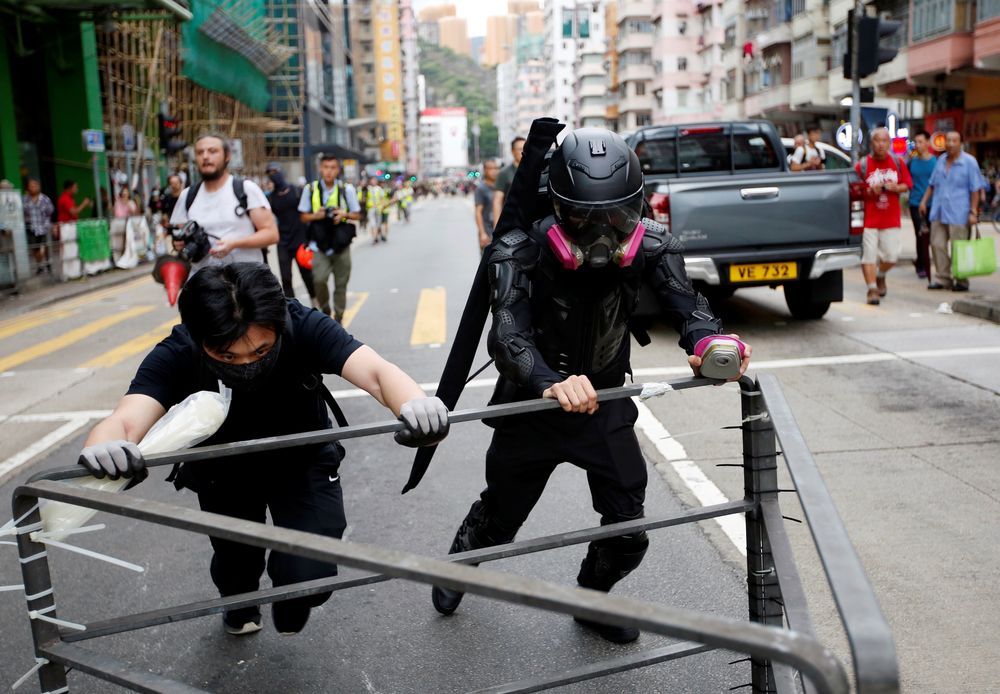 A protester nicknamed Ah Lung and another protester push a barricade to the frontline during a protest in Sham Shui Po neighbourhood of Hong Kong, China, August 11, 2019. u00e2u20acu201d Reuters pic