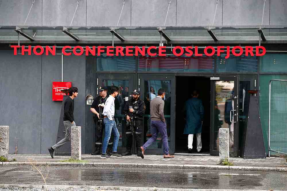 Armed police officers stand guard as Muslims from the Al-Noor mosque in Baerum arrive at the Thon hotel to attend the prayers during the first day of Eid al-Adha, in Oslo, Norway August 11, 2019. u00e2u20acu201d Terje Pedersen/NTB Scanpix via Reuters