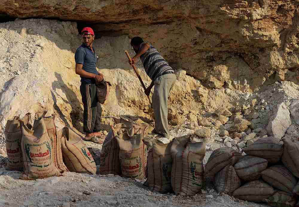 Volunteers fill grit in a bag to be used as sandbag defences, in Aqrabat, north of Idlib, Syria, June 20, 2019. u00e2u20acu201d Reuters pic