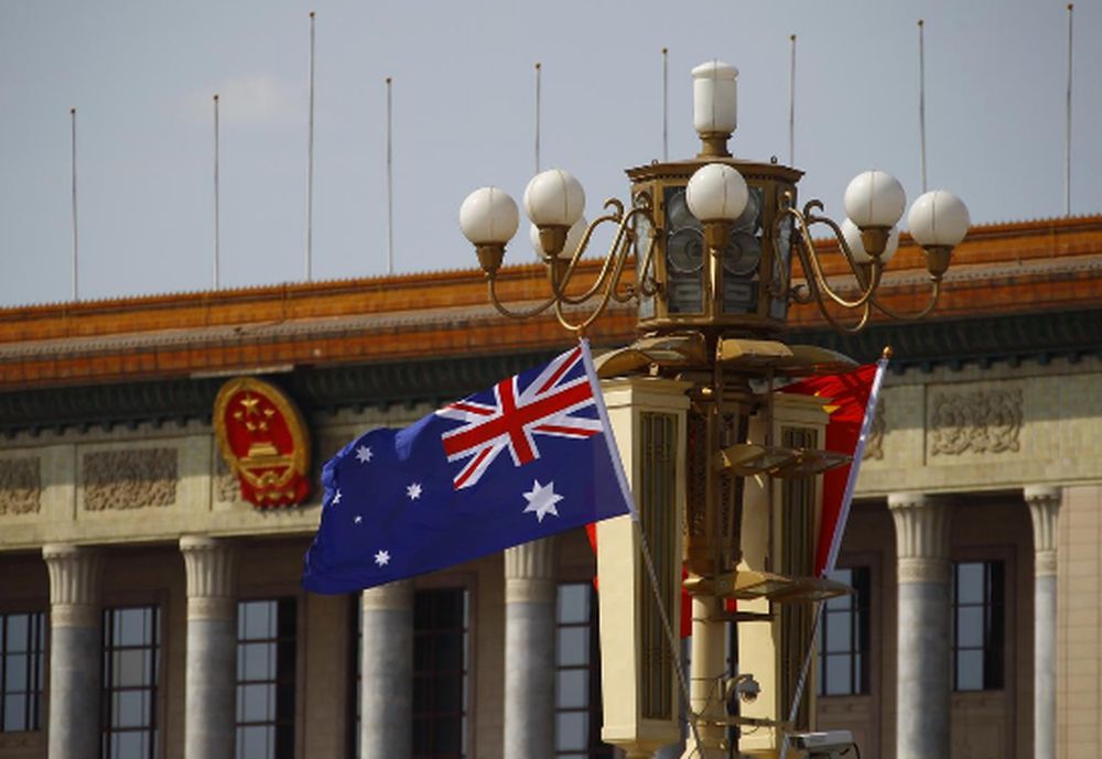 An Australian national flag flutters next to a Chinese national flag in front of the Great Hall of the People at the Tiananmen Square during Australian Prime Minister Julia Gillard's visit to Beijing April 9, 2013. u00e2u20acu201d Reuters pic
