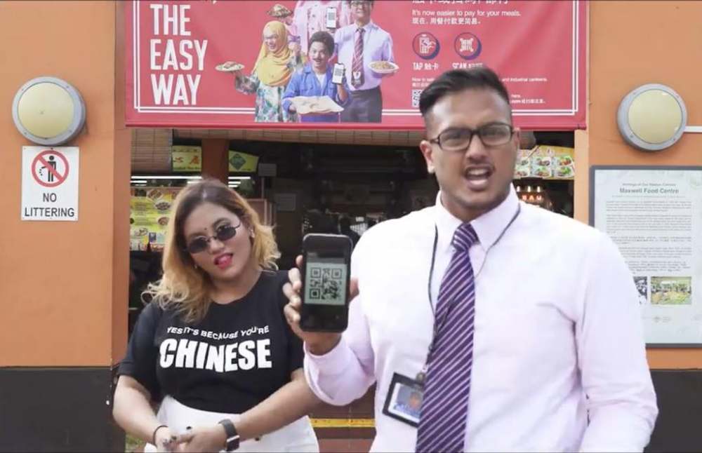 A rap video posted on Facebook by Preeti Nair (left) featuring rapper Subhas Nair (right) was directed against an e-payment advertisement (in the background). u00e2u20acu2022 TODAY pic