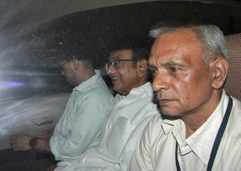 India's former Finance Minister Palaniappan Chidambaram (centre) sits in a vehicle after he was arrested by the Central Bureau of Investigation (CBI) officials in New Delhi August 21, 2019. u00e2u20acu201d Reuters pic