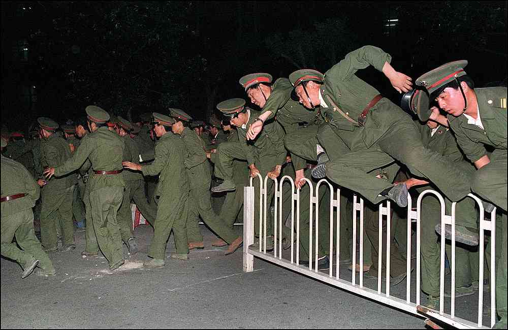 This file photo shows Peoples Liberation Army (PLA) soldiers leaping over a barrier on Tiananmen Square in central Beijing during heavy clashes with people and dissident students June 4, 1989. u00e2u20acu201d AFP pic