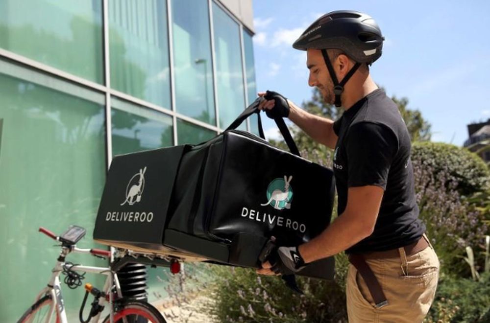 A Deliveroo worker unloads his bicycle as he makes a delivery in London, August 15, 2016. u00e2u20acu201d Reuters pic
