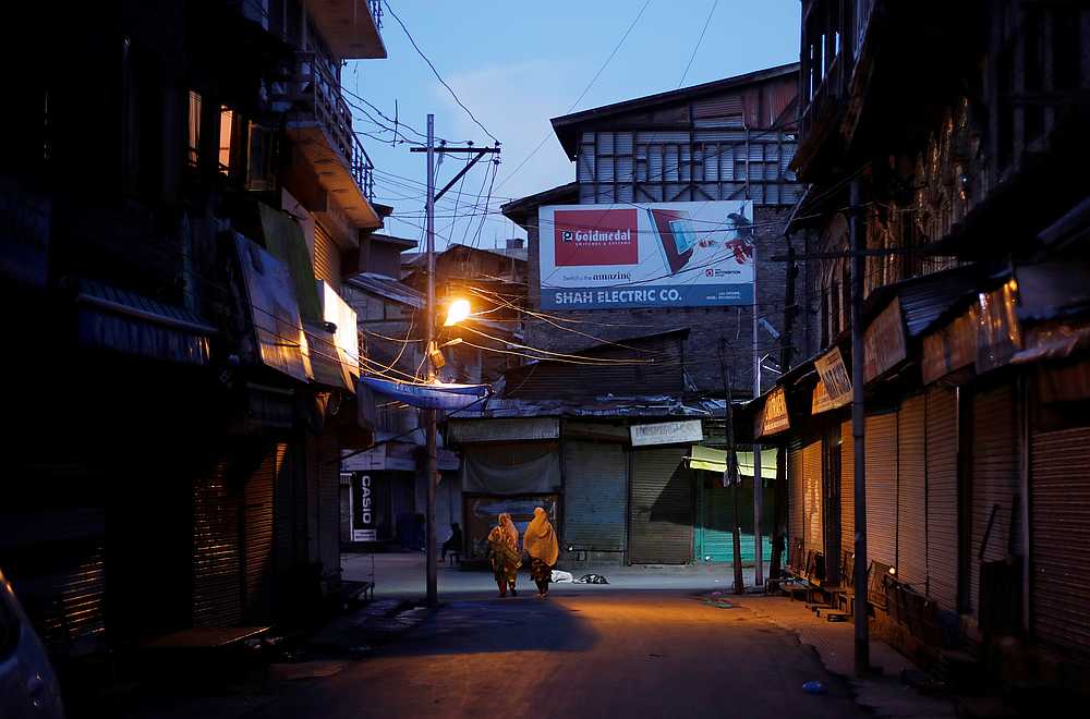 Kashmiri women walk in a deserted street during restrictions in Srinagar August 21, 2019. u00e2u20acu201d Reuters pic