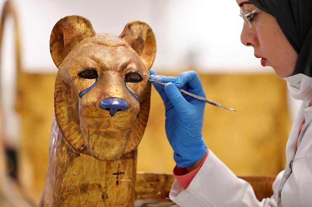 An Egyptian archaeologist restores the throne of King Tutankhamun at the conservation centre in the Grand Egyptian Museum on August 4, 2019. u00e2u20acu201d AFP pic
