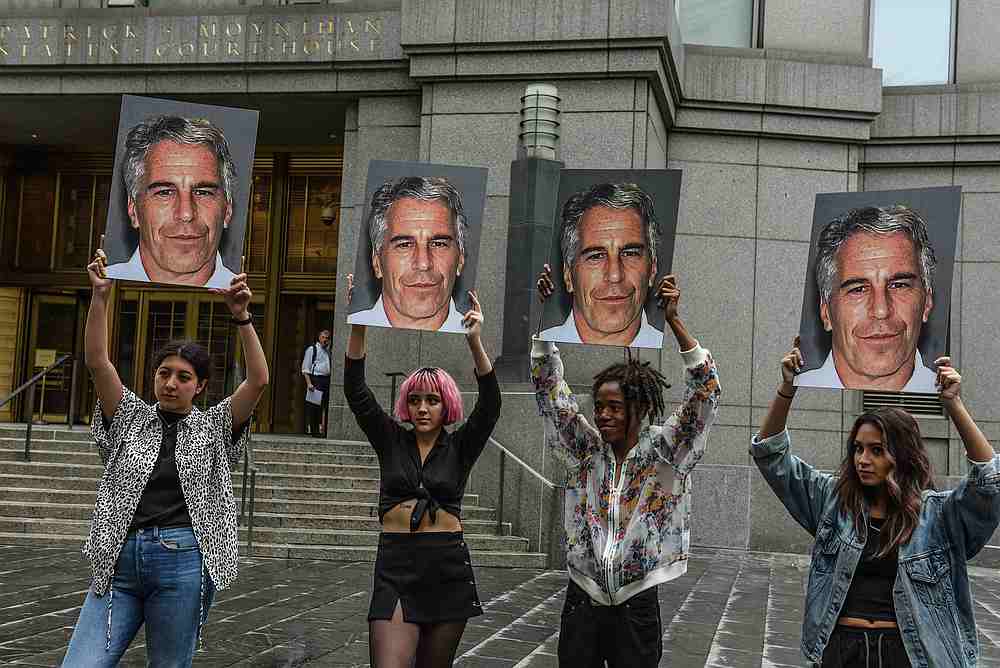 A protest group called 'Hot Mess' hold up photos of Jeffrey Epstein in front of the Federal courthouse in New York July 8, 2019. u00e2u20acu201d AFP pic
