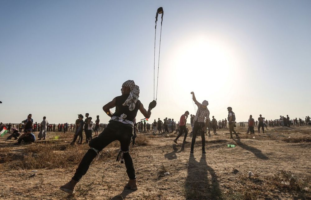 A Palestinian protester uses a slingshot to hurl stones during clashes with Israeli forces near the fence along the border with Israel in the eastern Gaza Strip on August 16, 2019. u00e2u20acu201d AFP pic