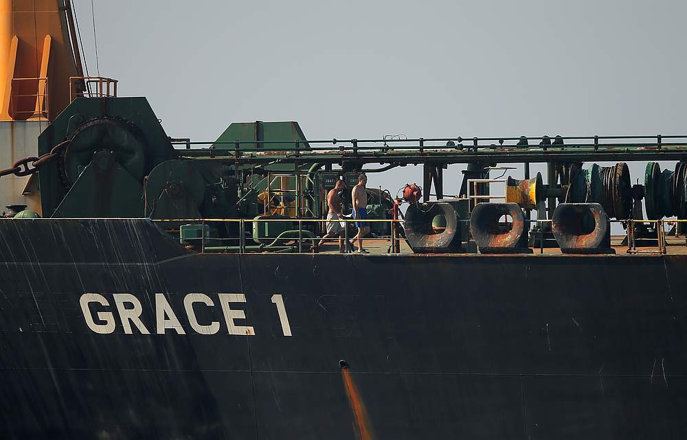 Crew members exercise aboard Iranian oil tanker Grace 1 as it sits anchored awaiting a court ruling on whether it can be freed after it was seized in July by British Royal Marines off the coast of the British Mediterranean territory, in the Strait of Gibr