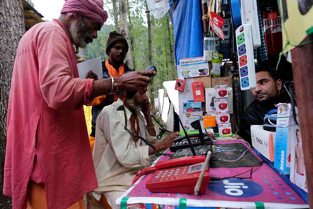 Hindu pilgrims make calls at a stall run by a Kashmiri Muslim before their journey towards the holy cave of Amarnath at a base camp near Pahalgam, in the Kashmir region July 26, 2019. u00e2u20acu201d Reuters pic