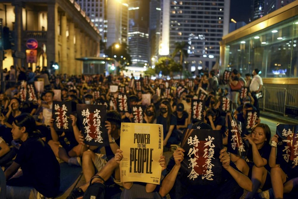 Pro-democracy protesters hold signs as they attend a rally in Hong Kong on August 16, 2019. u00e2u20acu201d AFP pic