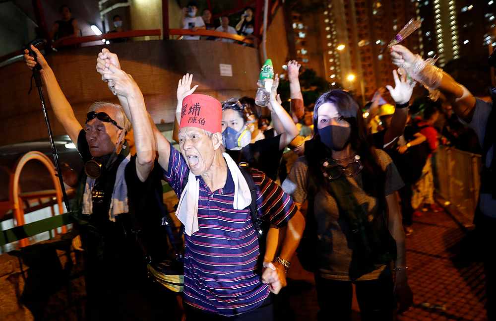 Anti-extradition bill protesters gesture as they try to confront with police officers during a march in Hong Kong,  August 4, 2019. u00e2u20acu201d Reuters pic