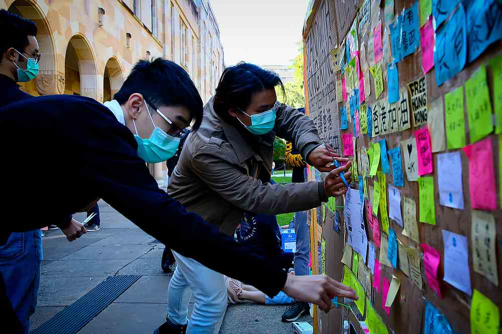Supporters of the Hong Kong pro-democracy protests posting notes on a makeshift 'Lennon Wall' at the University of Queensland in Brisbane August 9, 2019. u00e2u20acu201d AFP pic