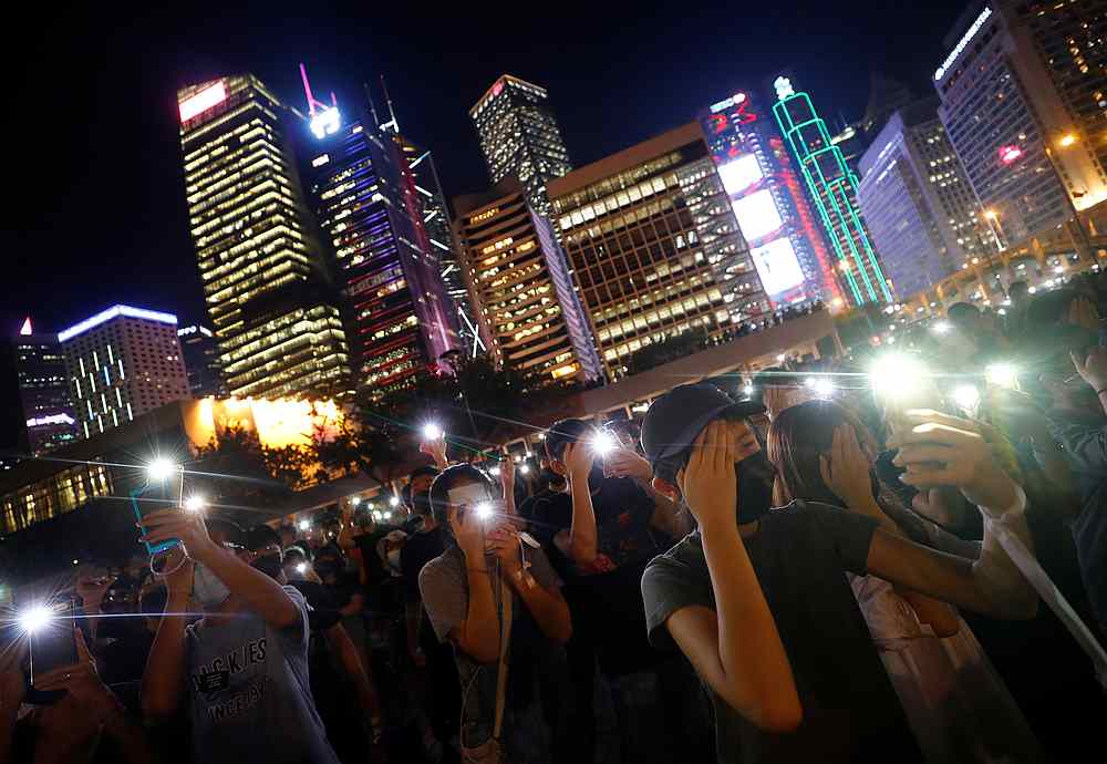 People hold their lit up smartphones during a students' rally to call for political reforms outside City Hall in Hong Kong August 22, 2019. u00e2u20acu201d Reuters pic
