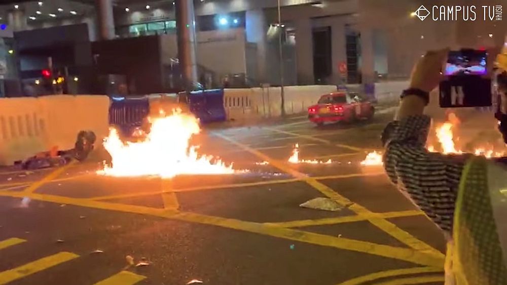 Fire on the surface of a road is seen after protesters throw a molotov cocktail towards Wan Chai police headquarters in Hong Kong, China August 5, 2019 in this still video image. u00e2u20acu201d Campus TV, HKUSU image via Reuters 